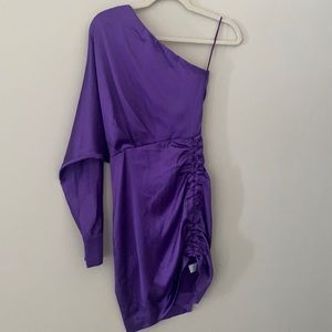 Purple satin one sleeved dress with asymmetric hem.